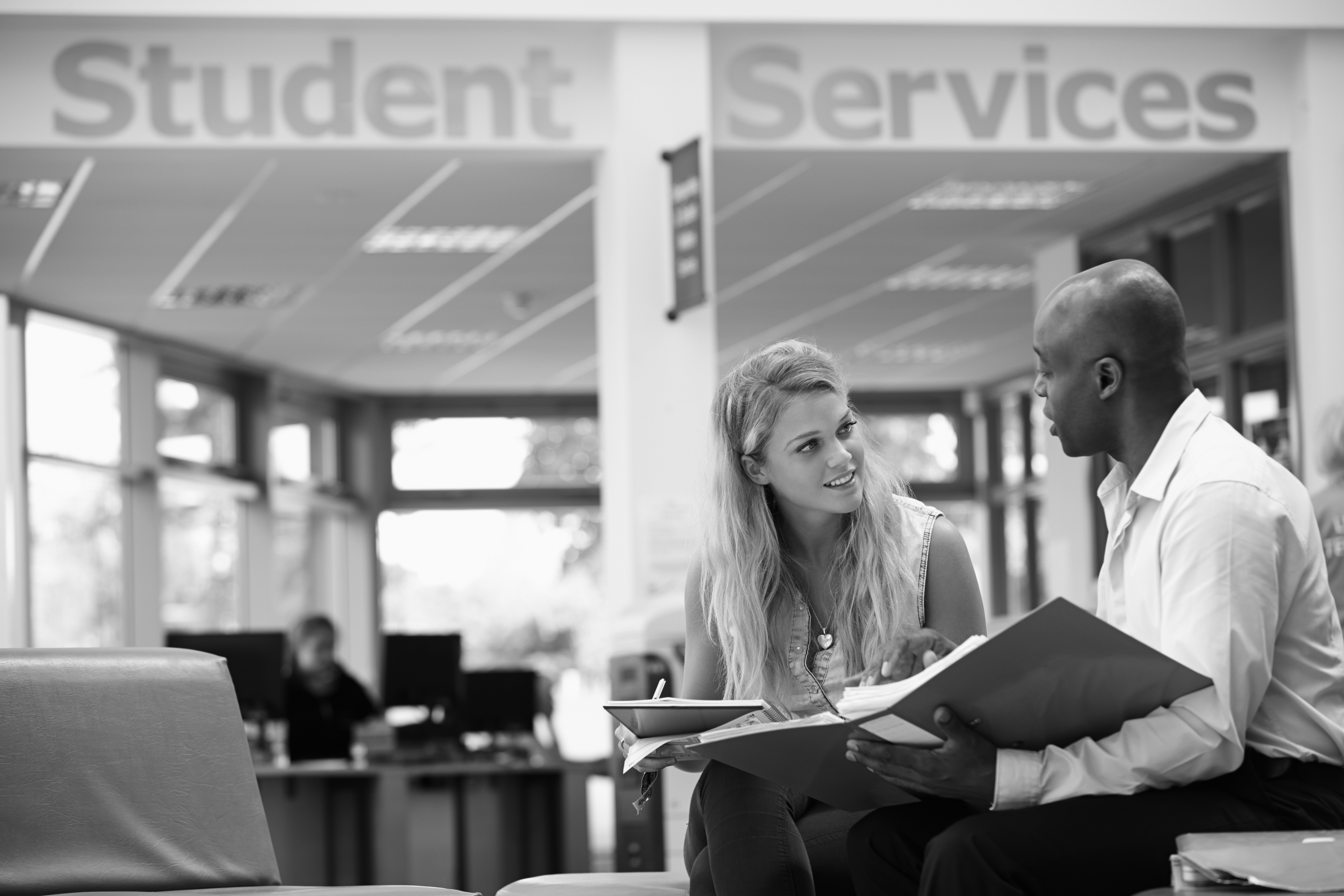 College Student Having Meeting With Tutor To Discuss Work